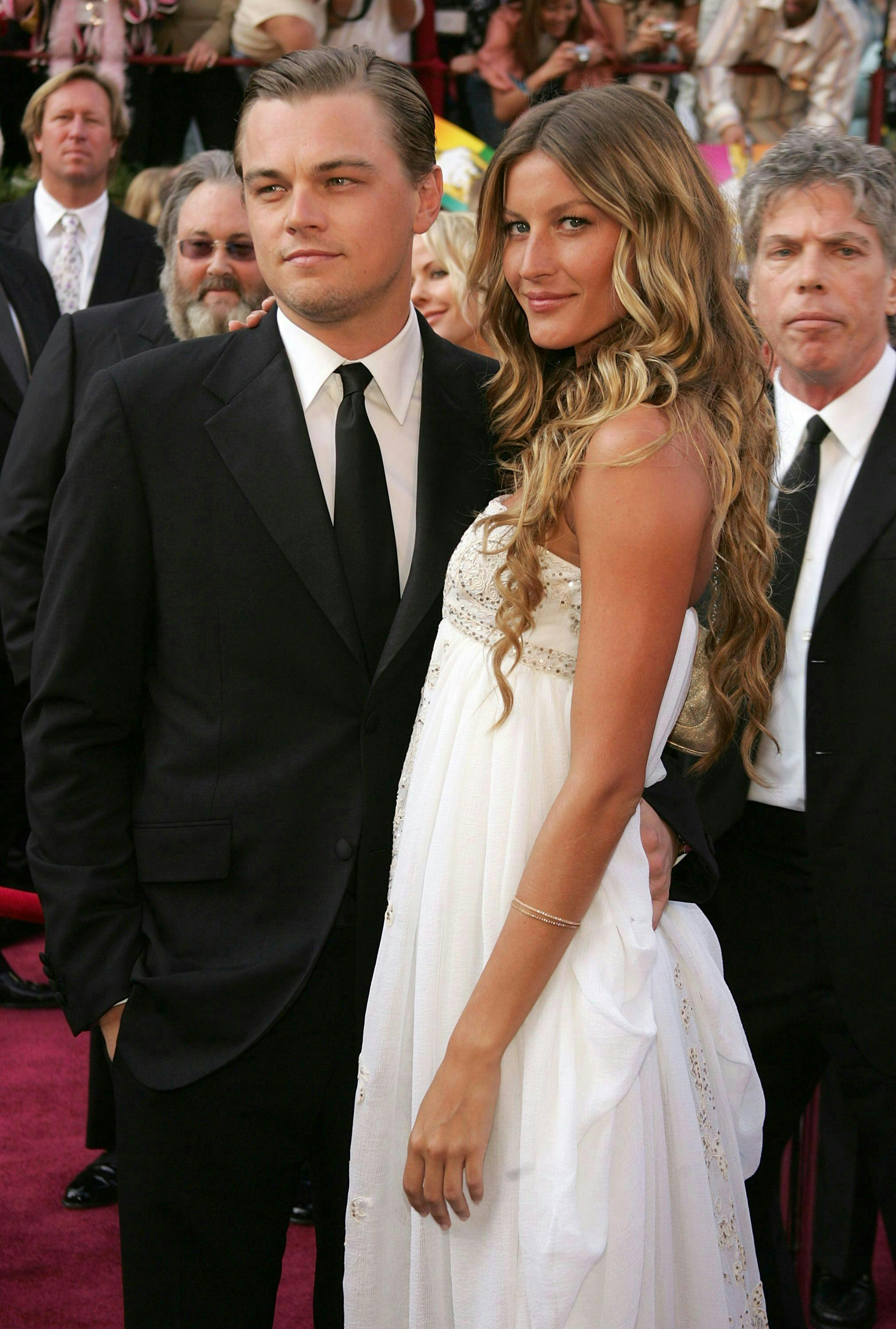 Gisele Bündchen and Leonardo DiCaprio pose together on a red carpet.