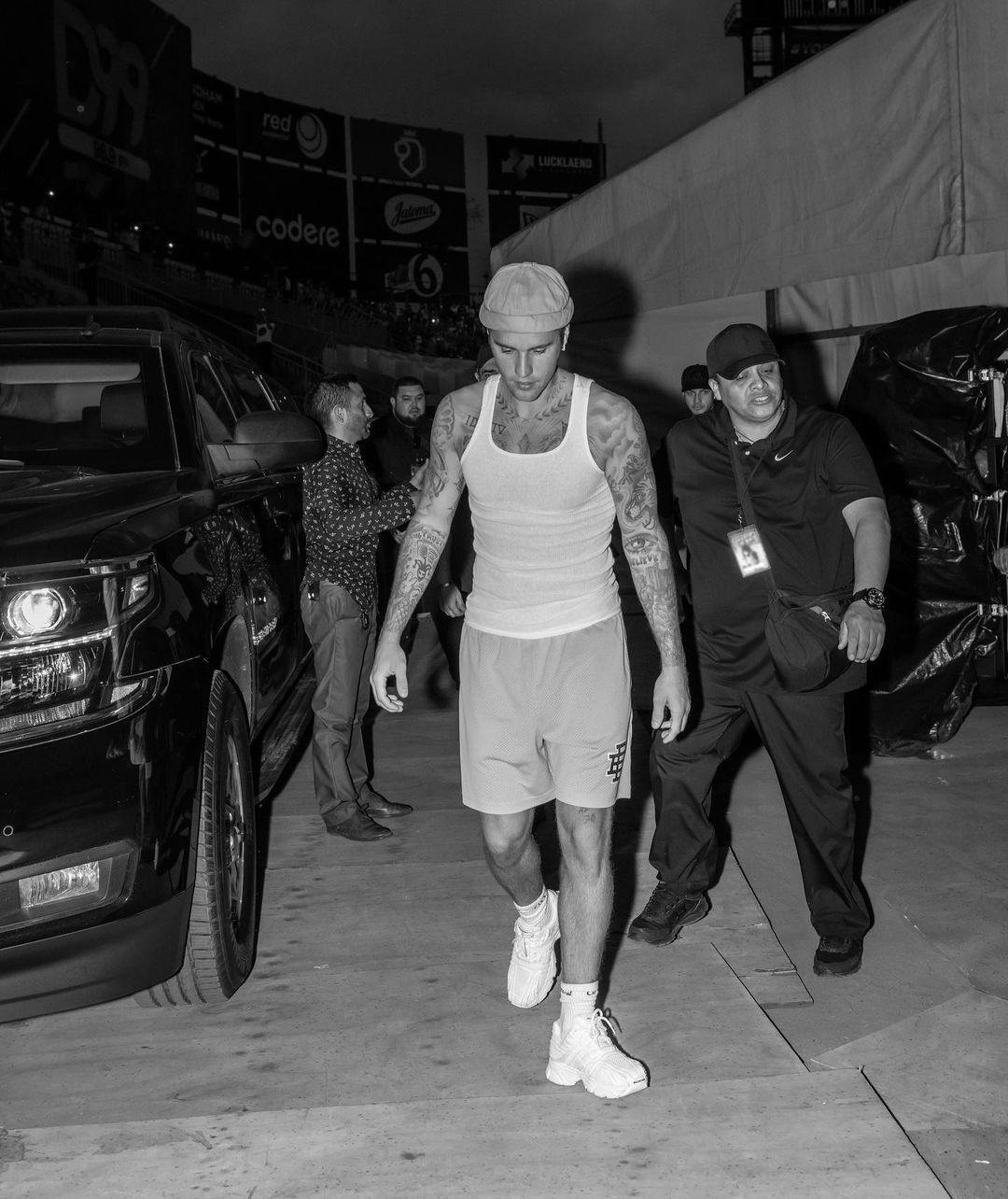 In a black and white photo, Justin Bieber sports a white tank and shorts.