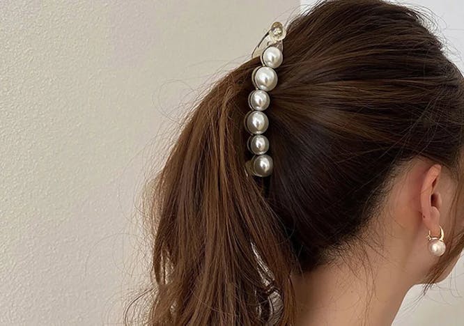 brown hair pearl clip ponytail beige wall