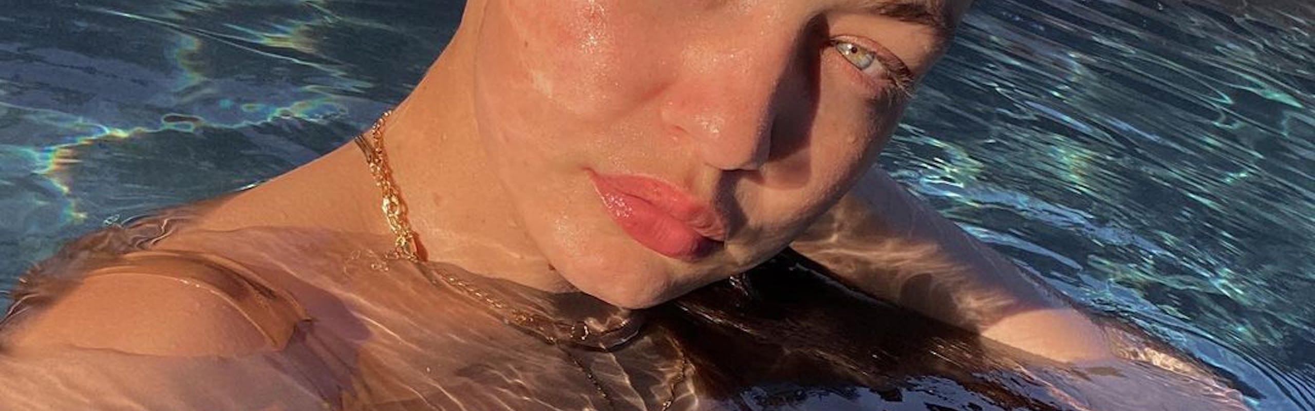 Gigi Hadid swims in a pool without makeup on. 