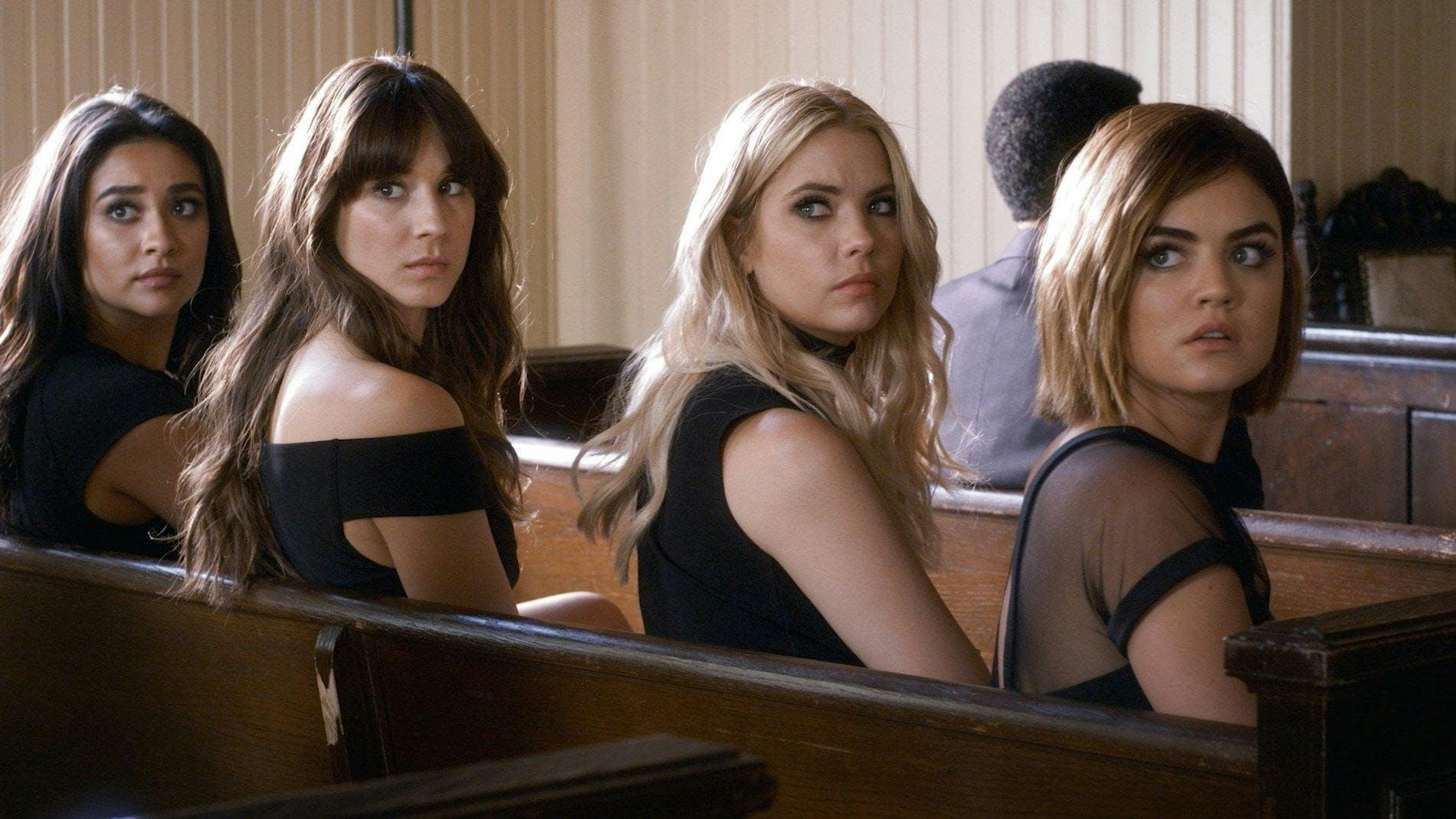 Shay Mitchell, Troian Bellisario, Ashley Benson, and Lucy Hale sit in a church pew on set of 'Pretty Little Liars.'