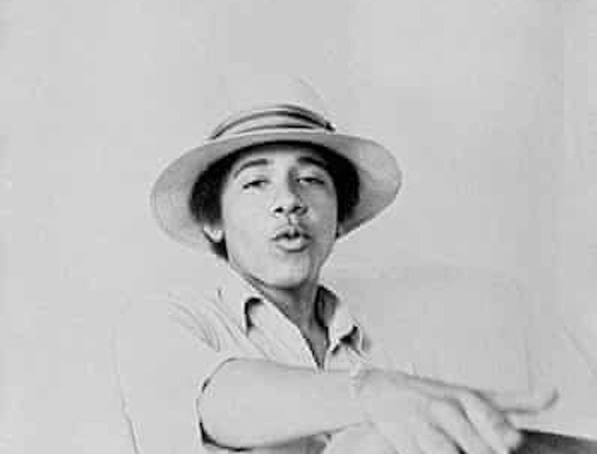 Young Barack Obama wearing a top hat, a polo shirt, and jeans