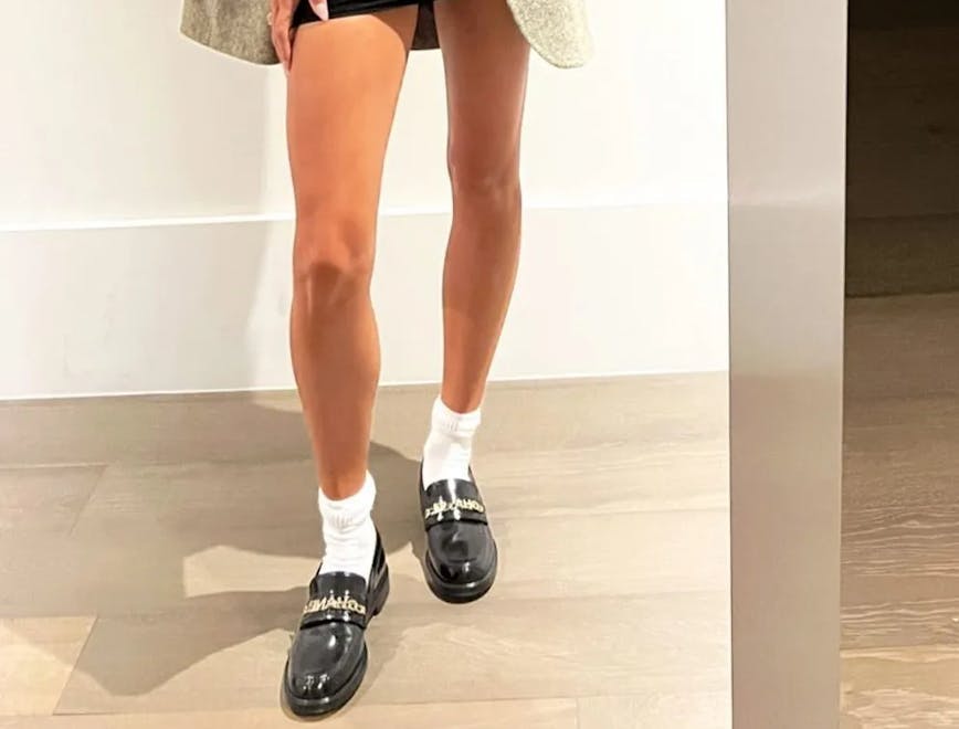 hailey bieber posing with socks and loafers