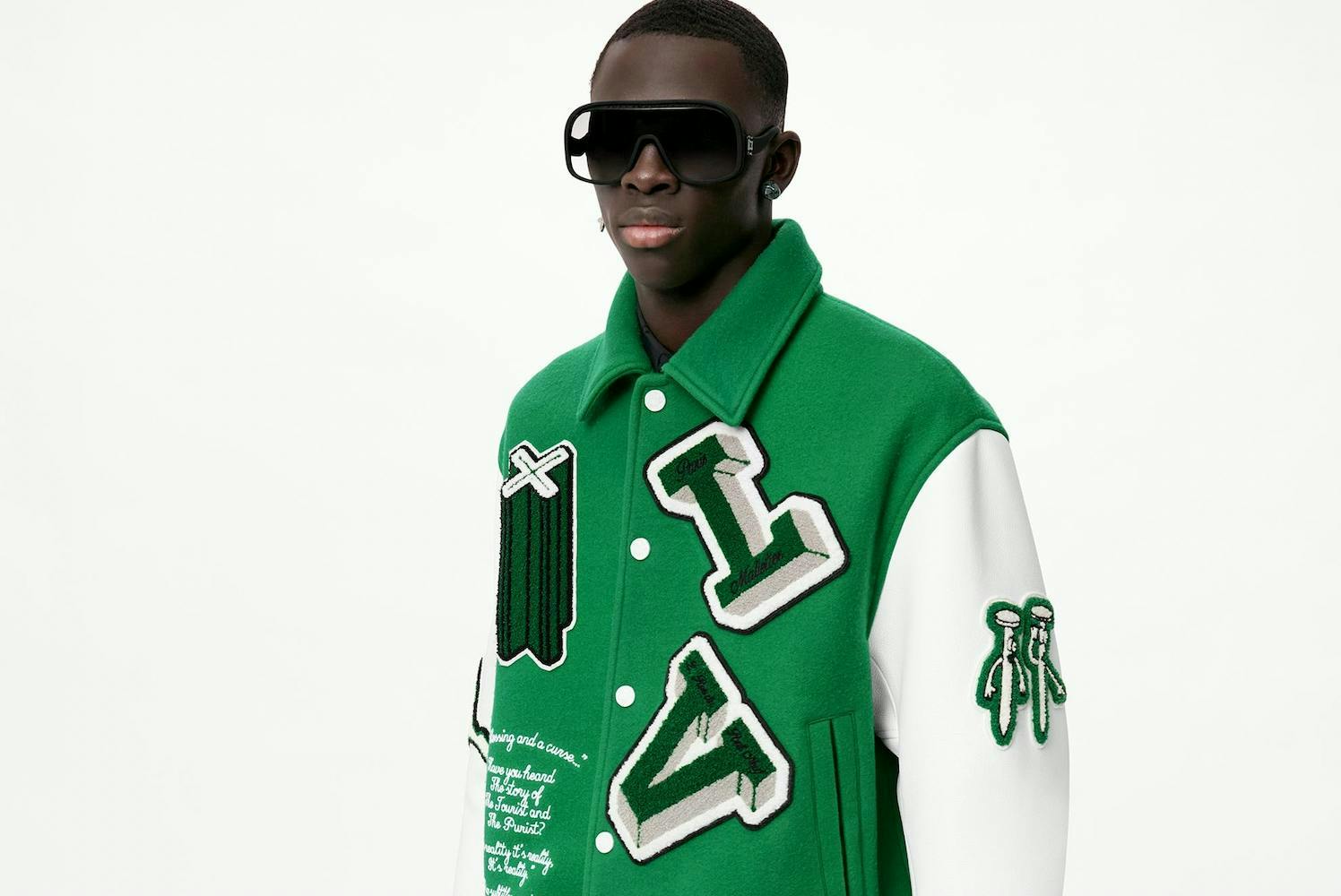 Male model wearing a green Louis Vuitton letterman jacket
