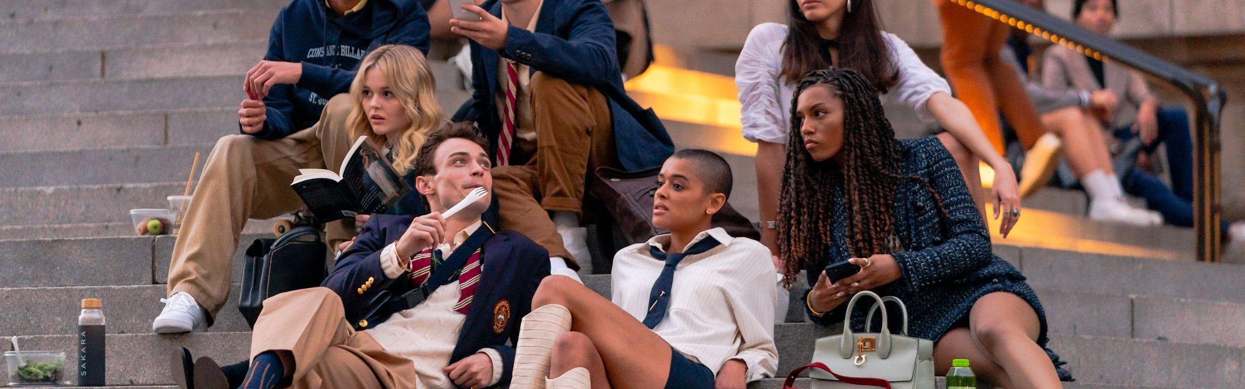 The cast of the Gossip Girl reboot sits on The Met steps.