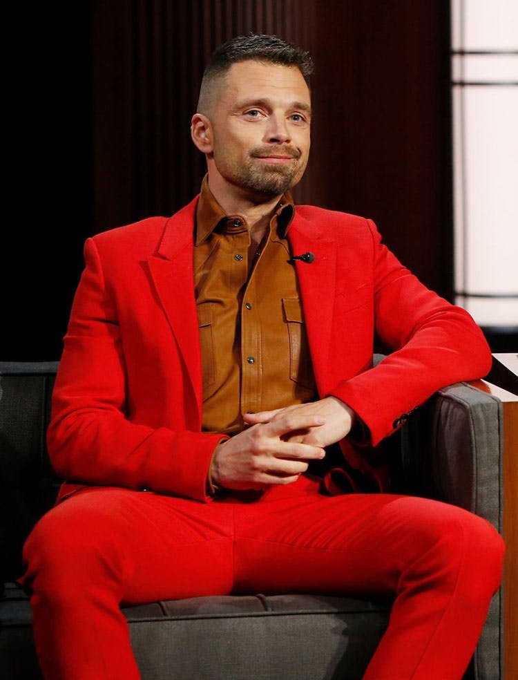 Sebastian Stan wearing a bright red suit while on jimmy Kimmel Live