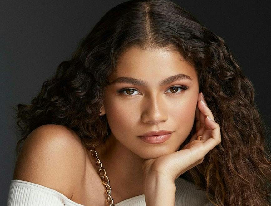 Zendaya in a white top on a black background
