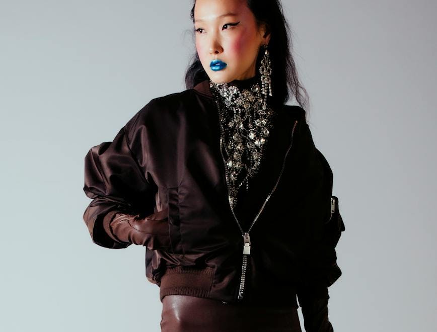Model in bomber jacket and blue lipstick