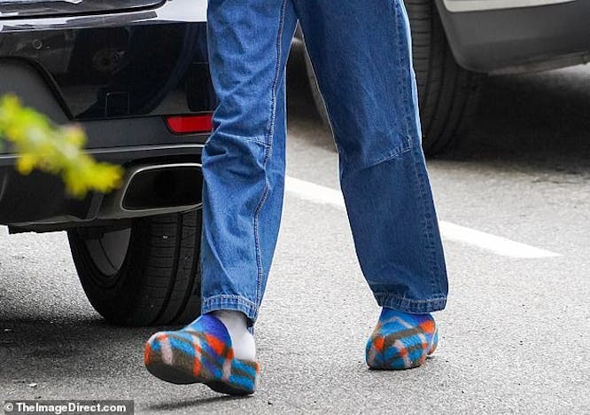 clothing pants person car sunglasses shoe alloy wheel wheel tire jeans