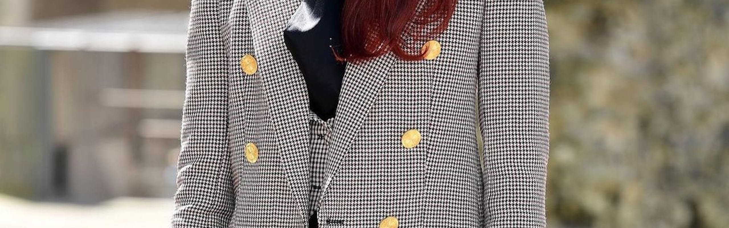 Zendaya in a grey houndstooth blazer and red hair.