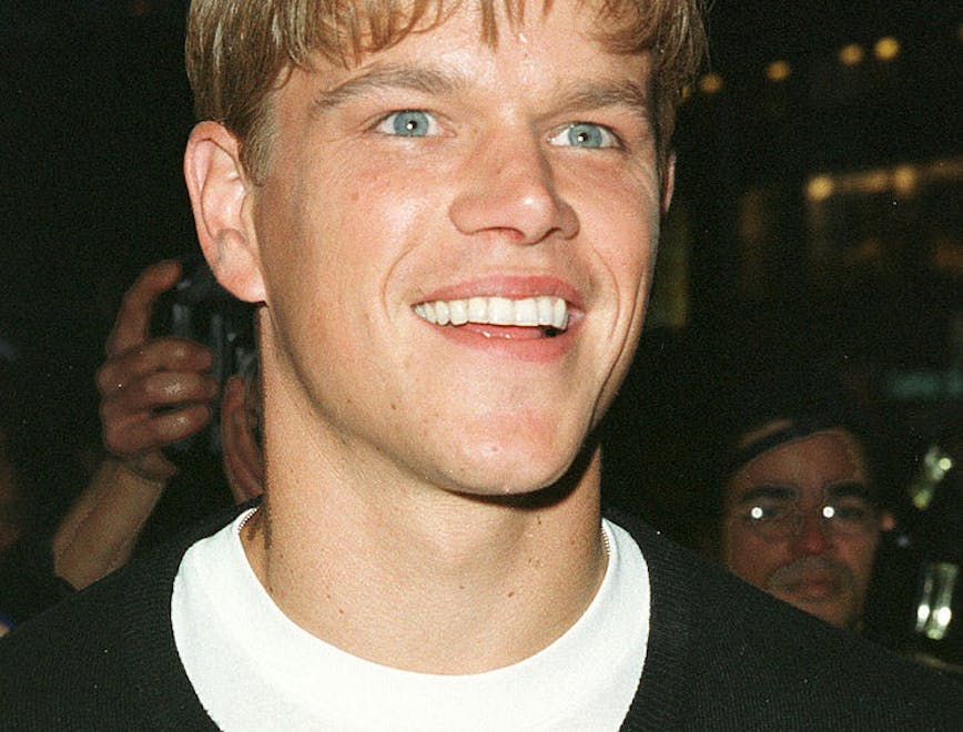 A young Matt Damon smiling to the camera.