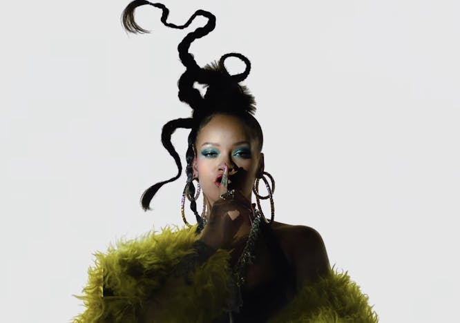 Rihanna in a yellow fur coat on a white background.