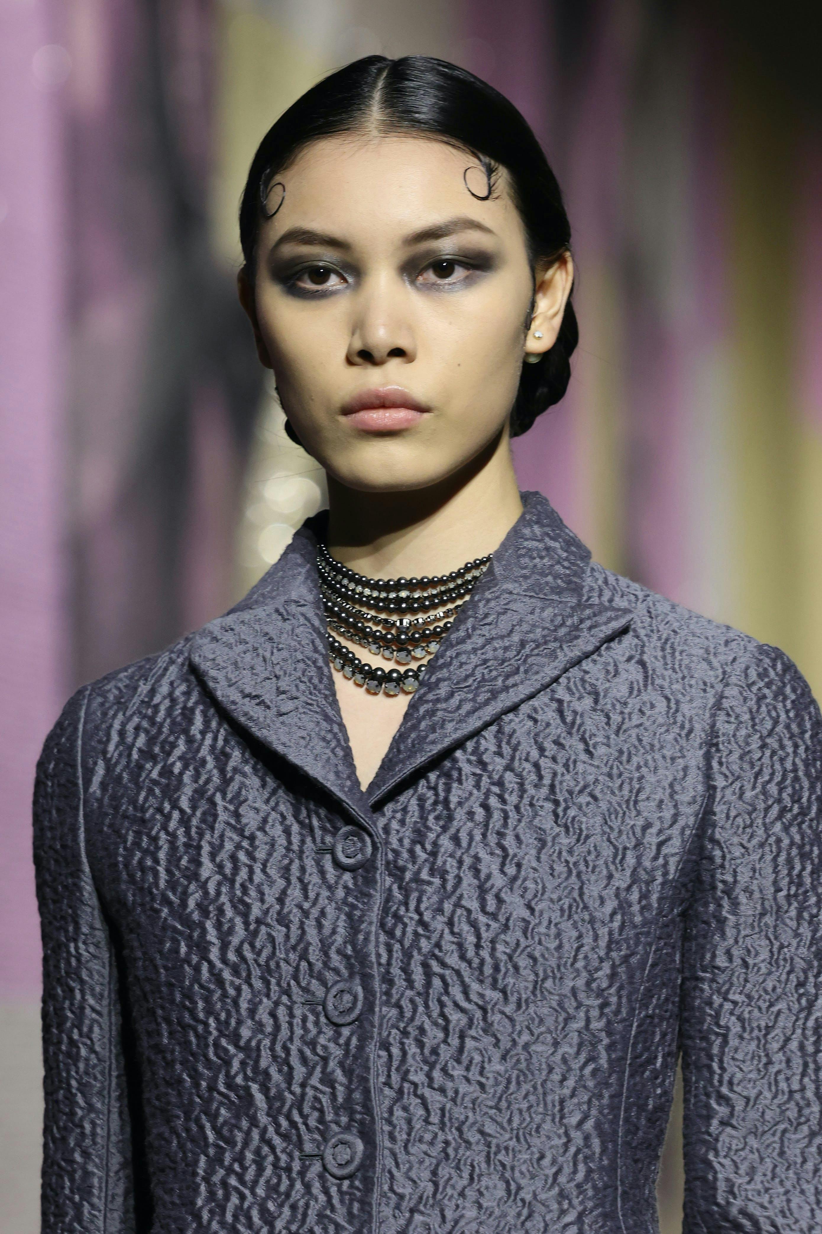 Model wears grey top as she walks the Spring/Summer 2023 Dior show.