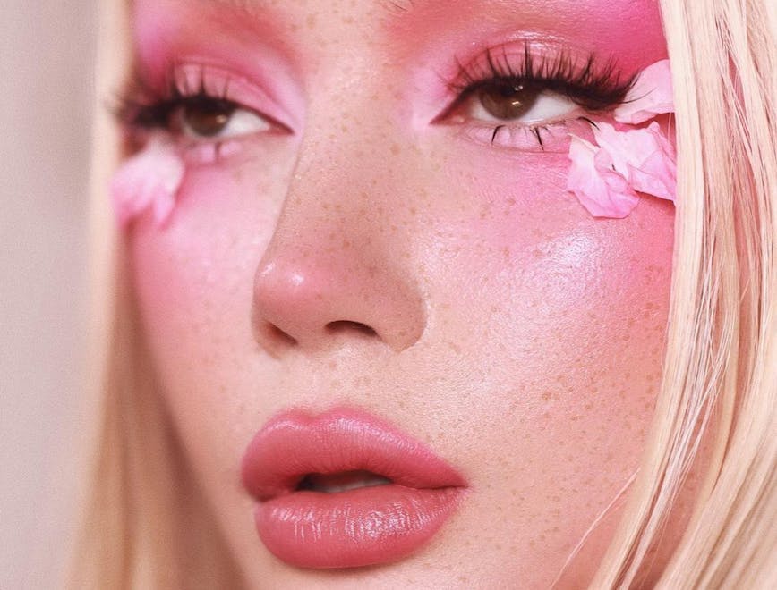 Girl wears pink eyeshadow and lipstick.