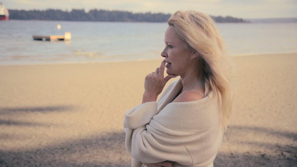 Pamela Anderson wears a beige robe.
