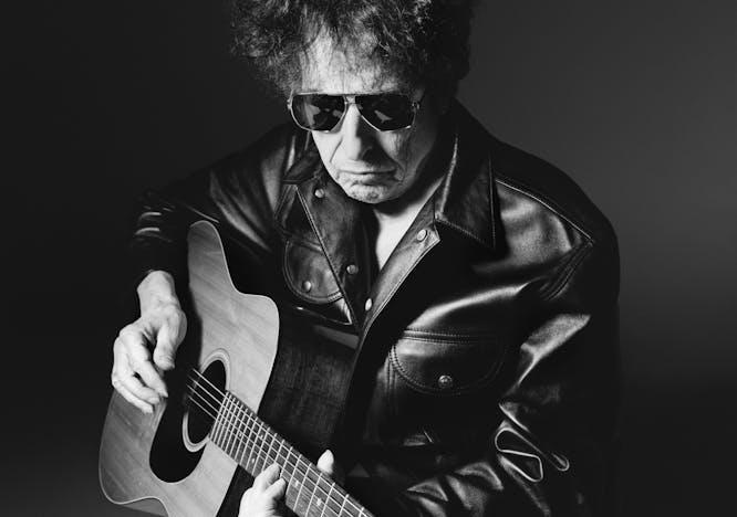 Bob Dylan wears black leather jacket, black leather pants and sunglasses.