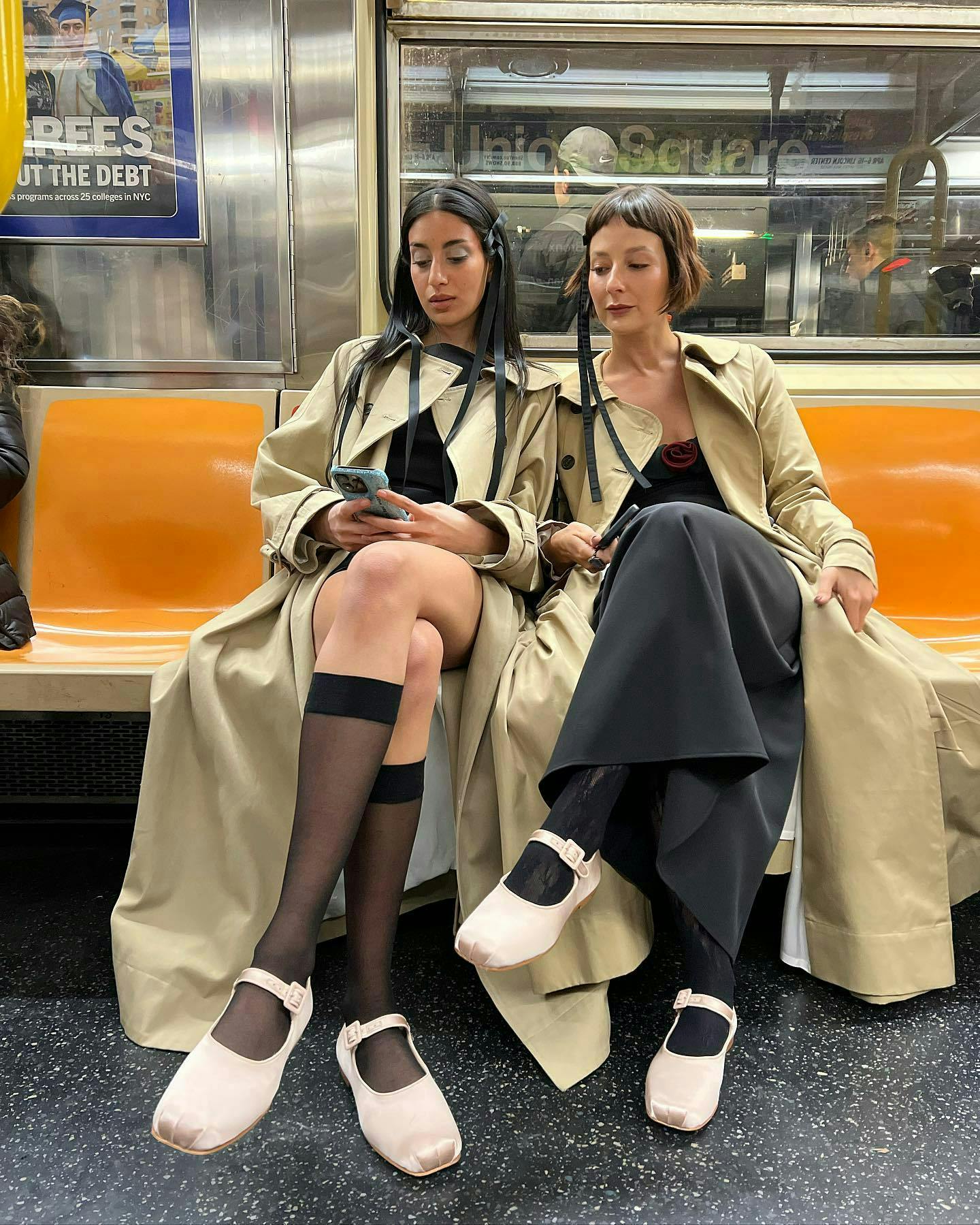 two women sitting on the subway