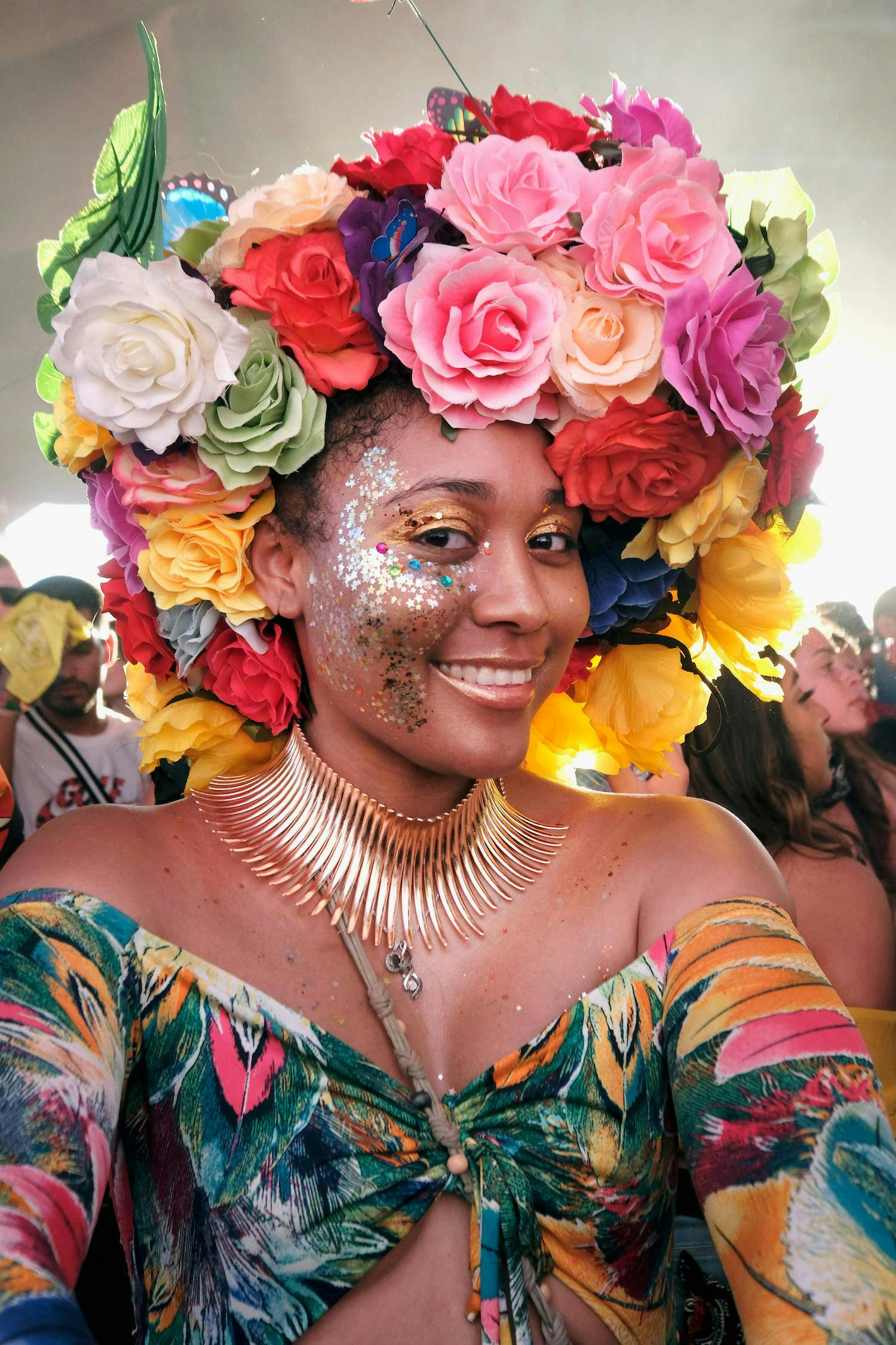 Coachella attendees with festival makeup and a colorful flower hat