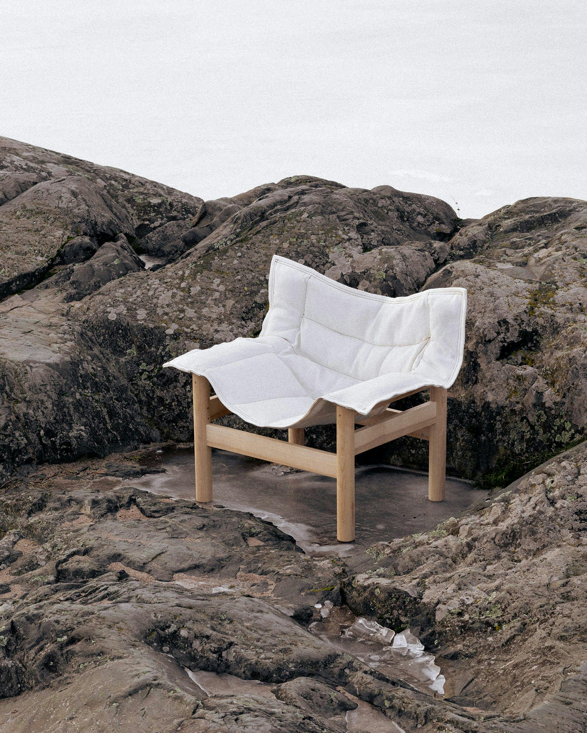 White chair on rocks.