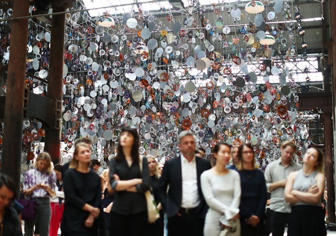 Group of people admire an art installation.