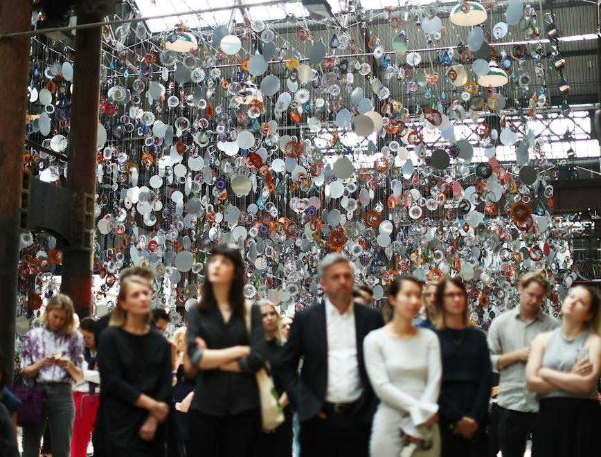 Group of people admire an art installation.