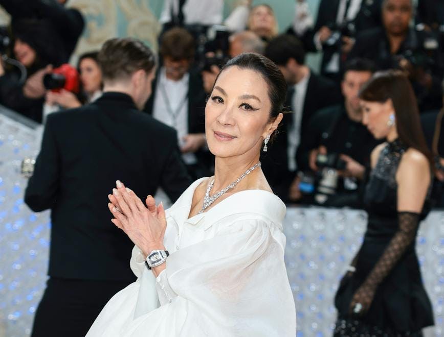 Michelle Yeoh in a black and white dress.