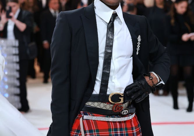 ASAP Rocky in a black blazer and plaid skirt.