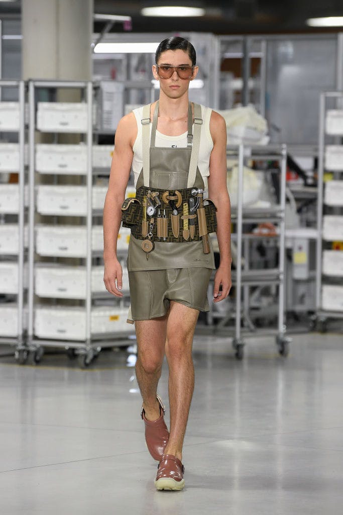 A model in a jumpsuit and utility belt.