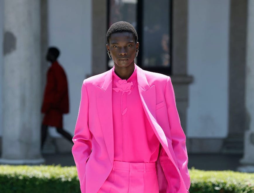 A model in a pink short suit.