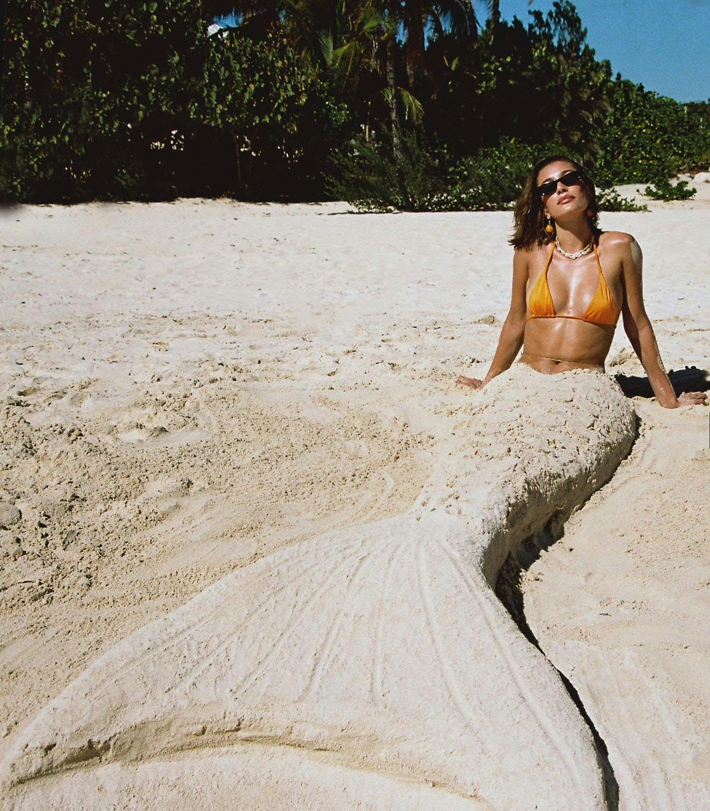 Hailey Bieber channels her inner mermaid in flaming orange bikini.