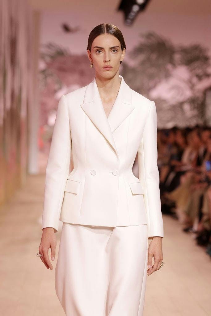 A model in a white blazer.