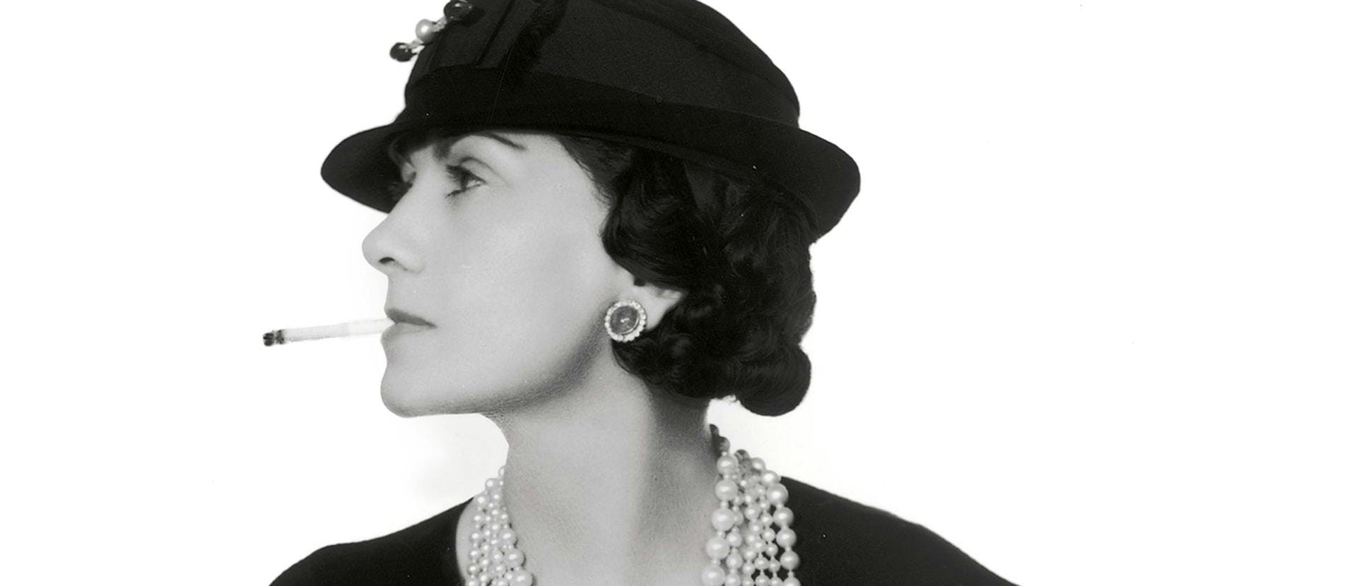 A black and white photo of Coco Chanel.