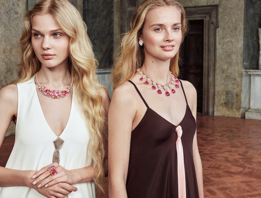 Two models wearing Van Cleef & Arpels ruby red necklaces.