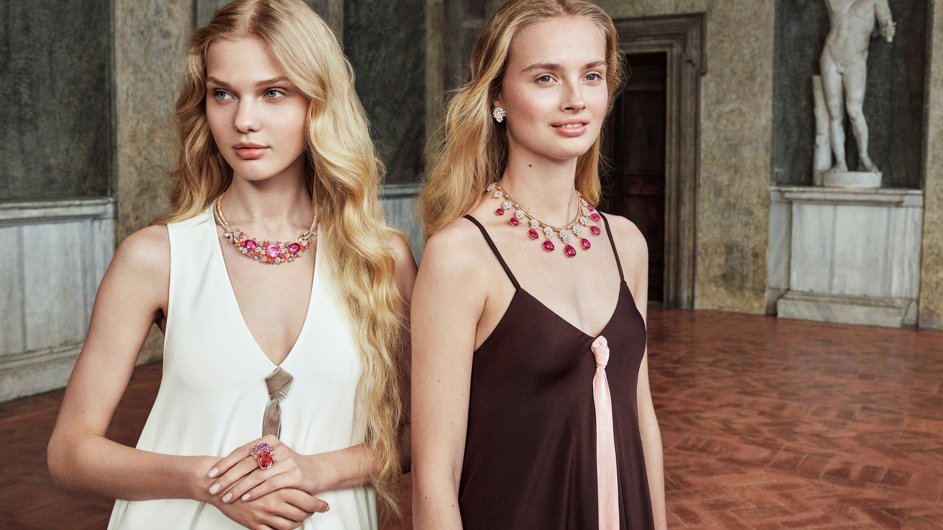 Two models wearing Van Cleef & Arpels ruby red necklaces.