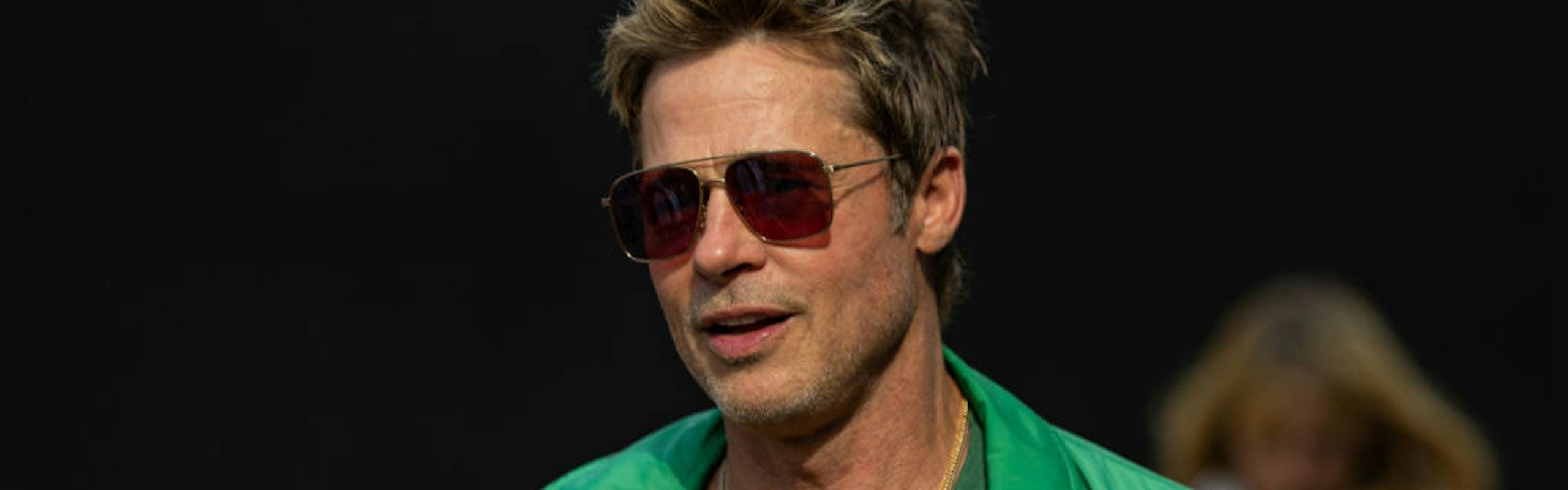 Brad Pitt in a green jacket and shirt celebrities at F1 British Grand Prix 2023