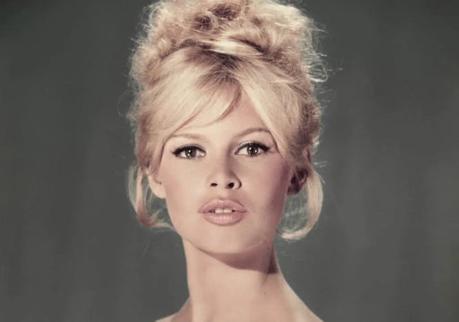 Brigitte Bardot in a green top looking at the camera; french style icons