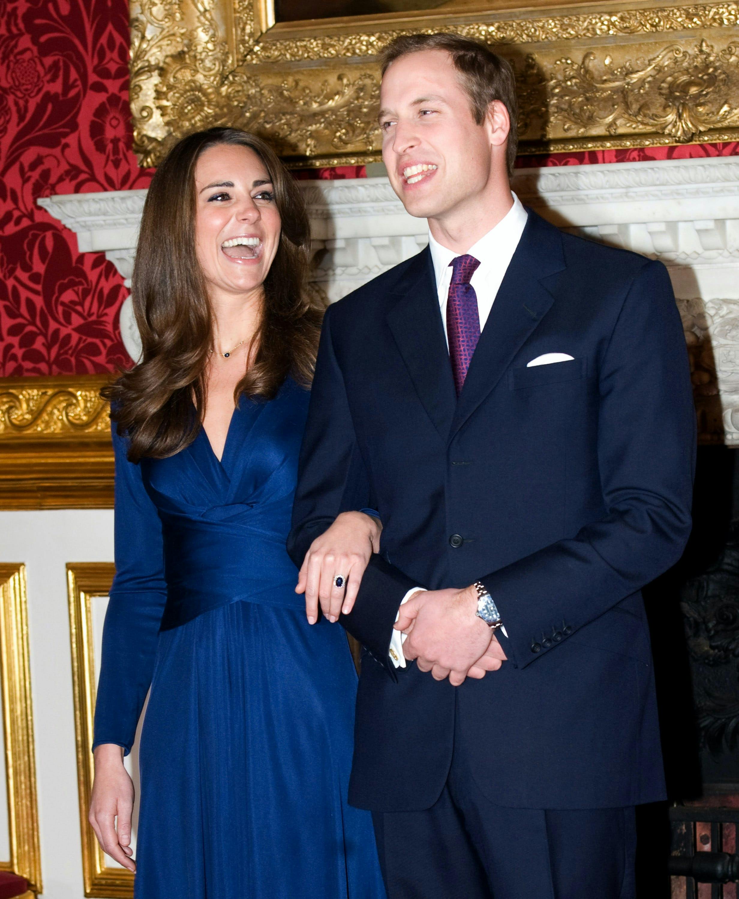 british royal titles Kate Middleton and Prince William laughing arm and arm at an event.