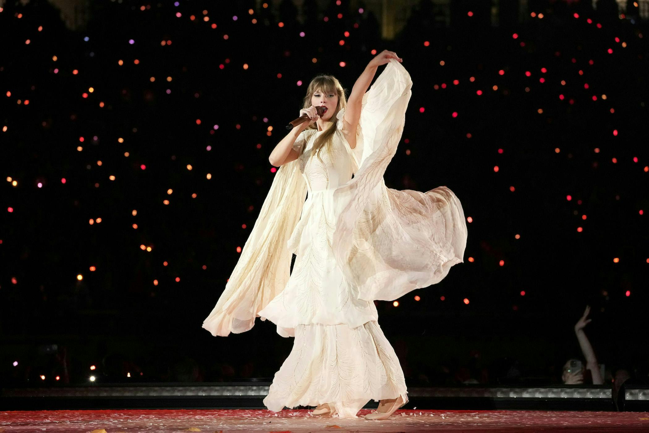 taylor swift in flowy white dress for eras tour documentary