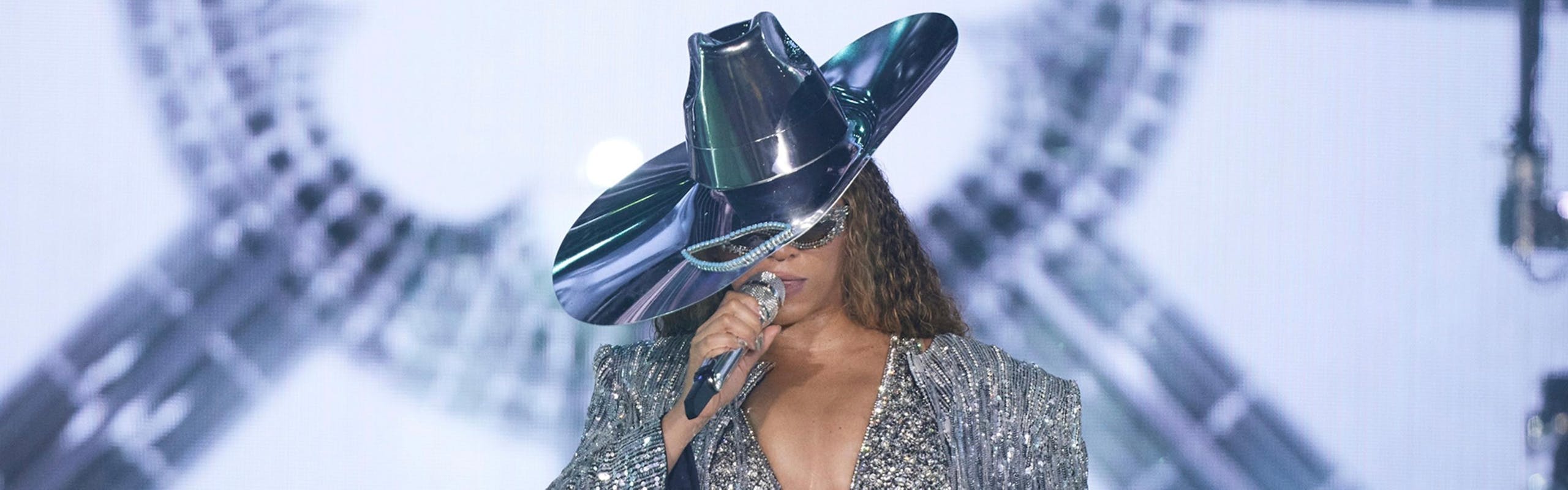 beyonce in sequin mini dress, fringe maxi coat, and cowboy hat