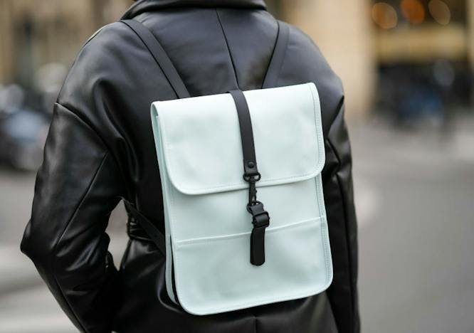 model wearing white designer backpack