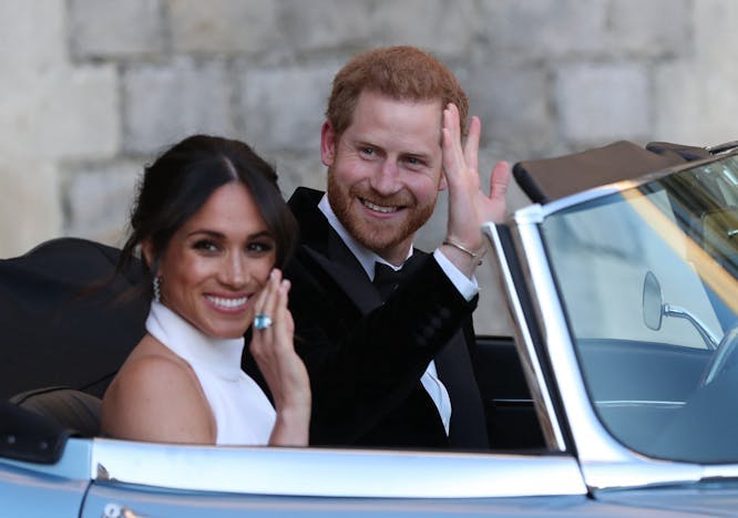 Prince Harry and Meghan Markle waving from car.