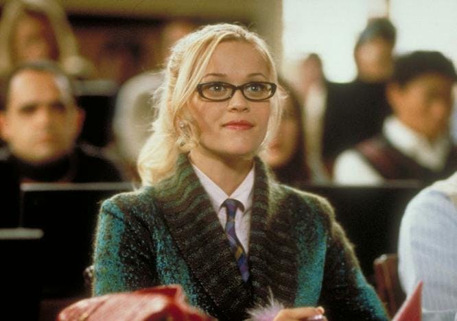 reese witherspoon as elle woods wearing glasses and green sweater; history of on campus style