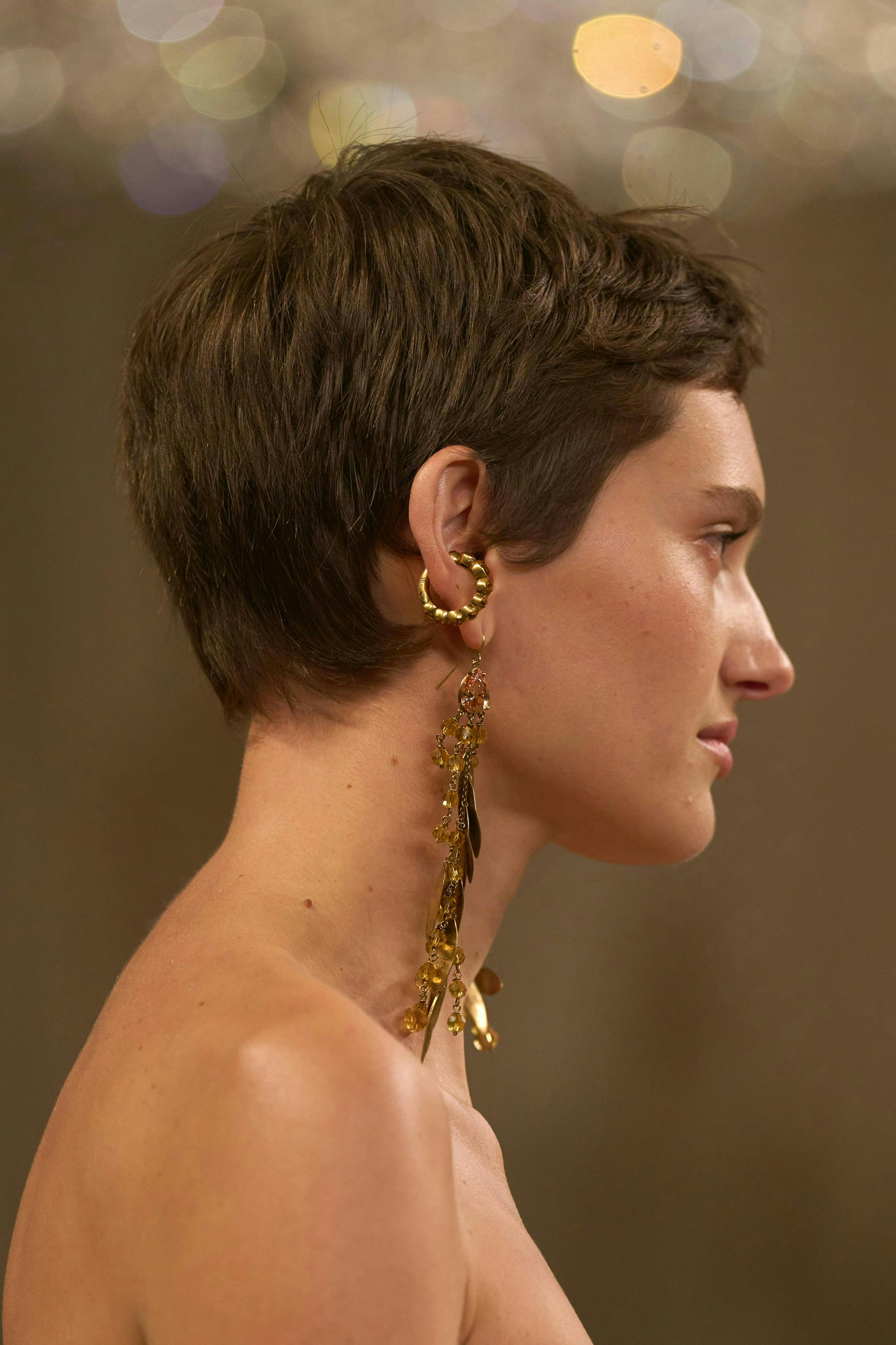 Side profile of woman with pixie cut.