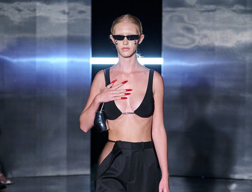 model in black bra top and maxi skirt with red nails