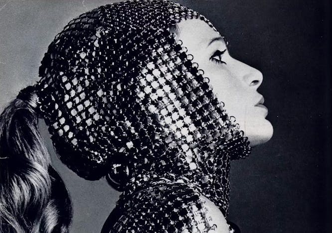 Black and white image of a model in silver top/hood