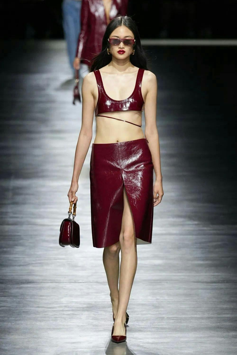 gucci model wearing ss24 red leather gucci look on runway
