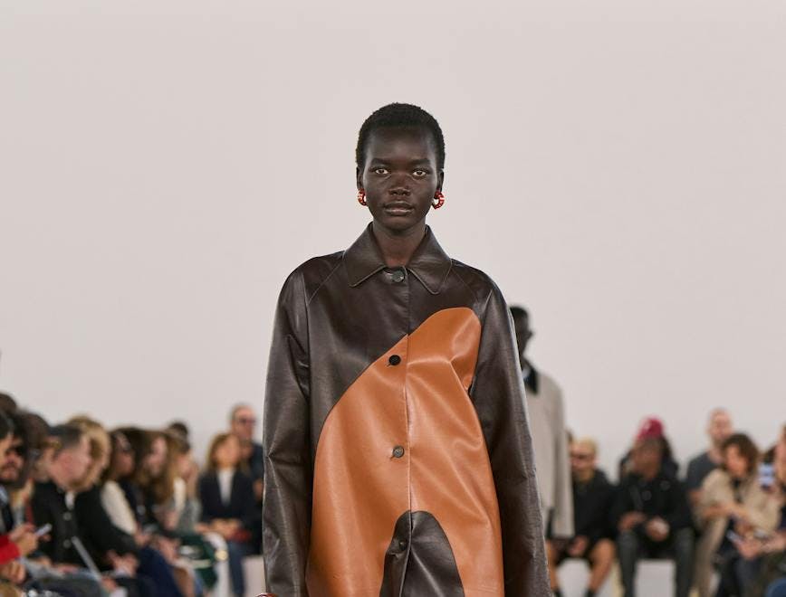 model in dark and light brown colorblocked coat