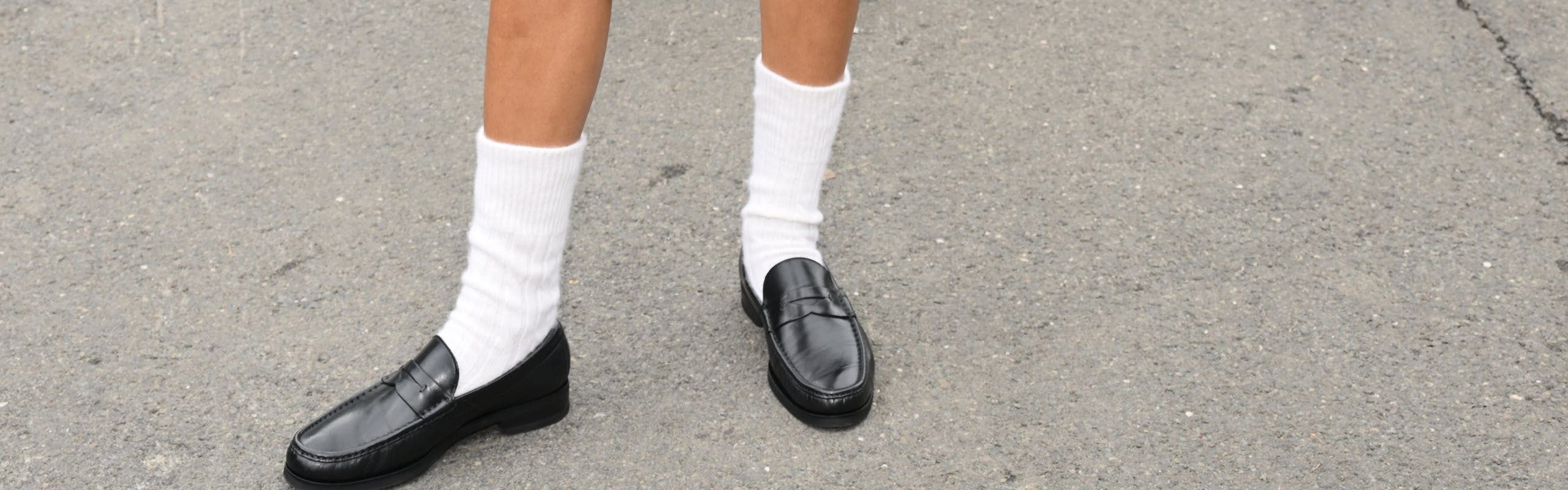 Yasmin Finney in a black blazer, white socks and black loafers