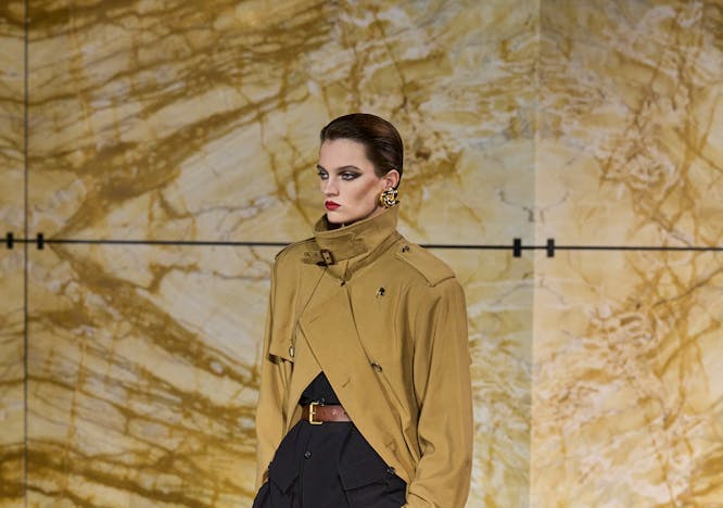 model in deconstructed trench coat and high waisted black pants