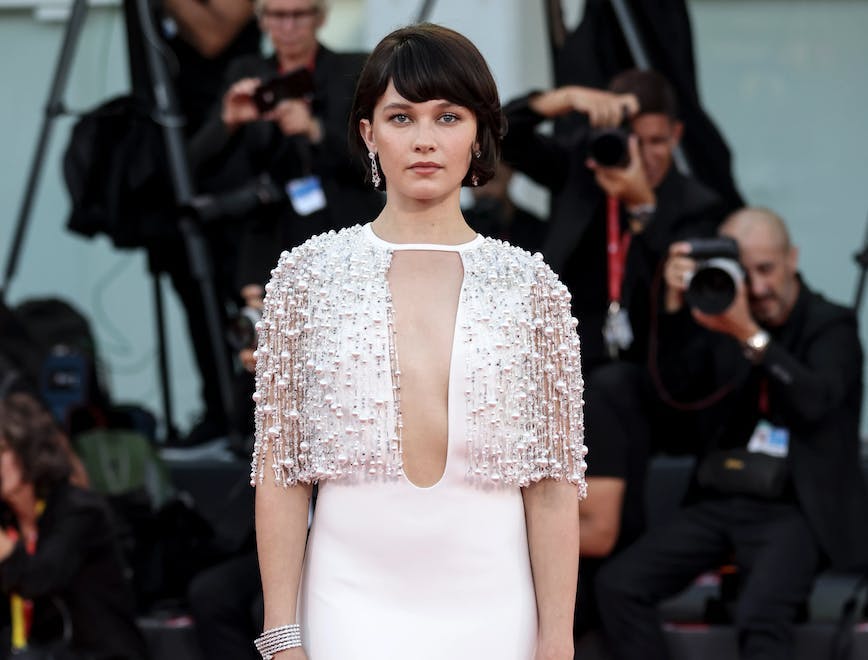 cailee speany in a sequined white dress looking at the camera